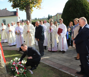 Złożenie kwiatów przez Wójta Gminy Grybów pod tablicą pamiątkową